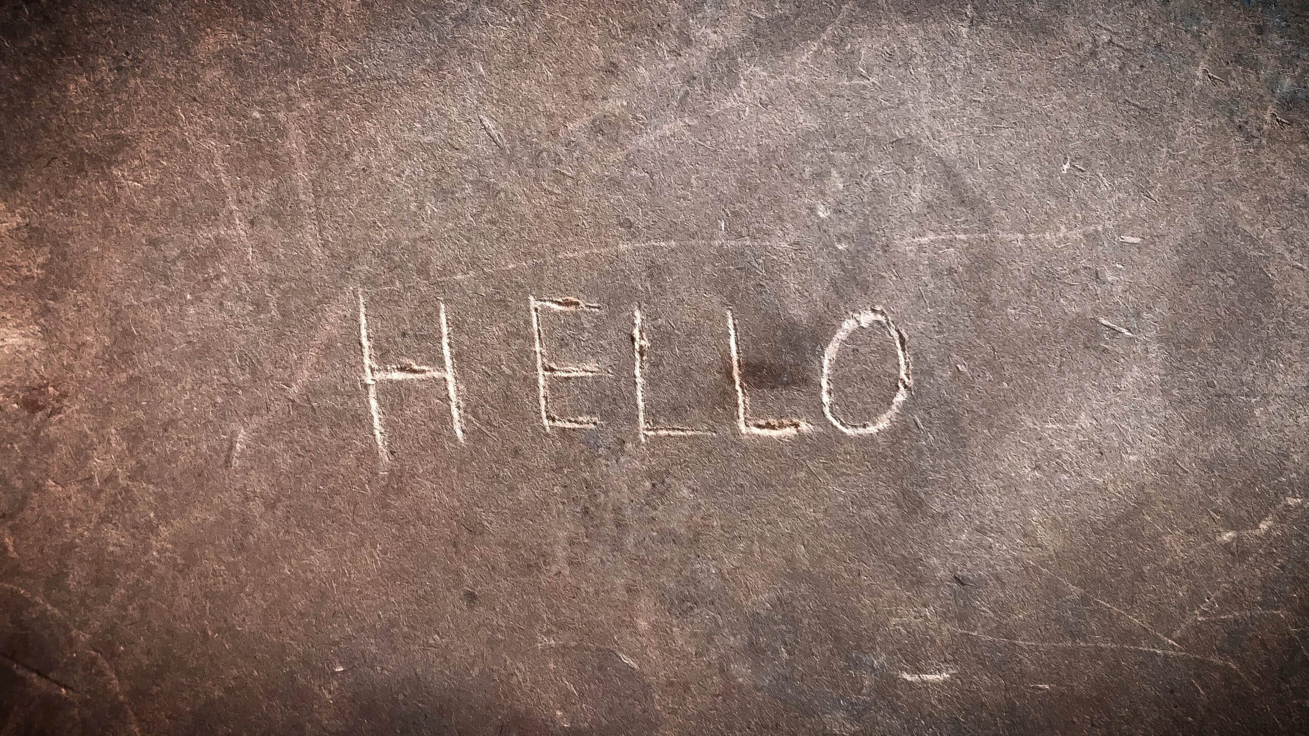 The word "hello" etched into cement.